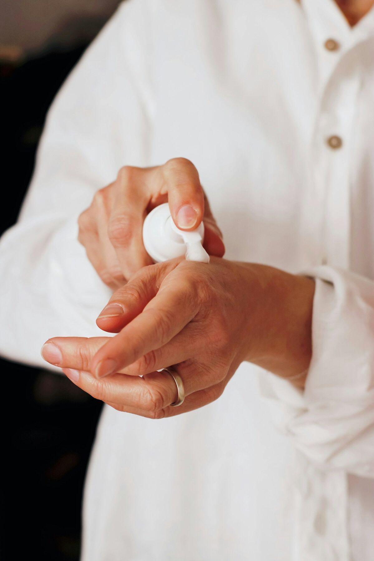 Therapist warming a cream between her hands