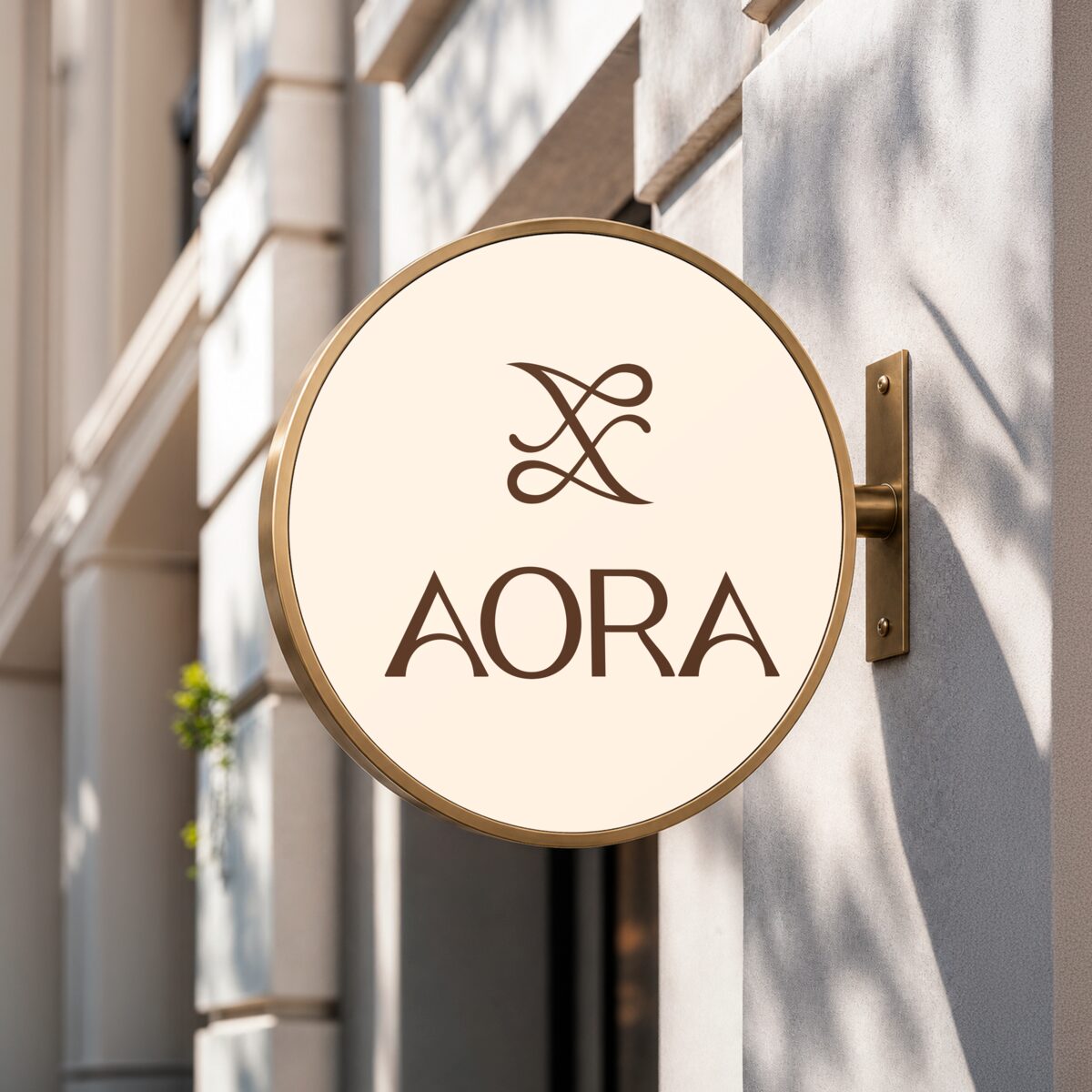 The round AORA sign hanging outside the studio