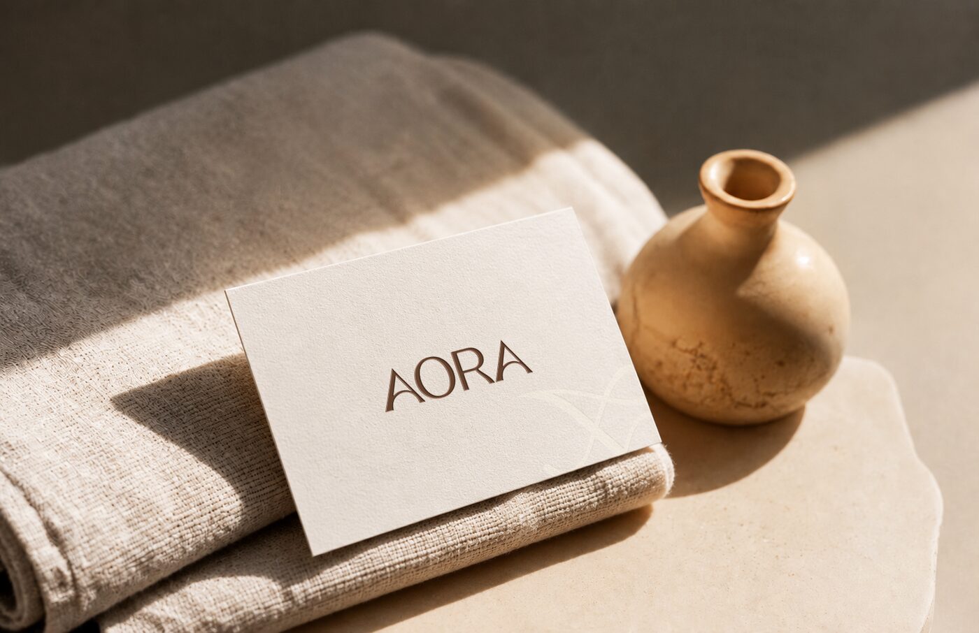 AORA name card on soft linen